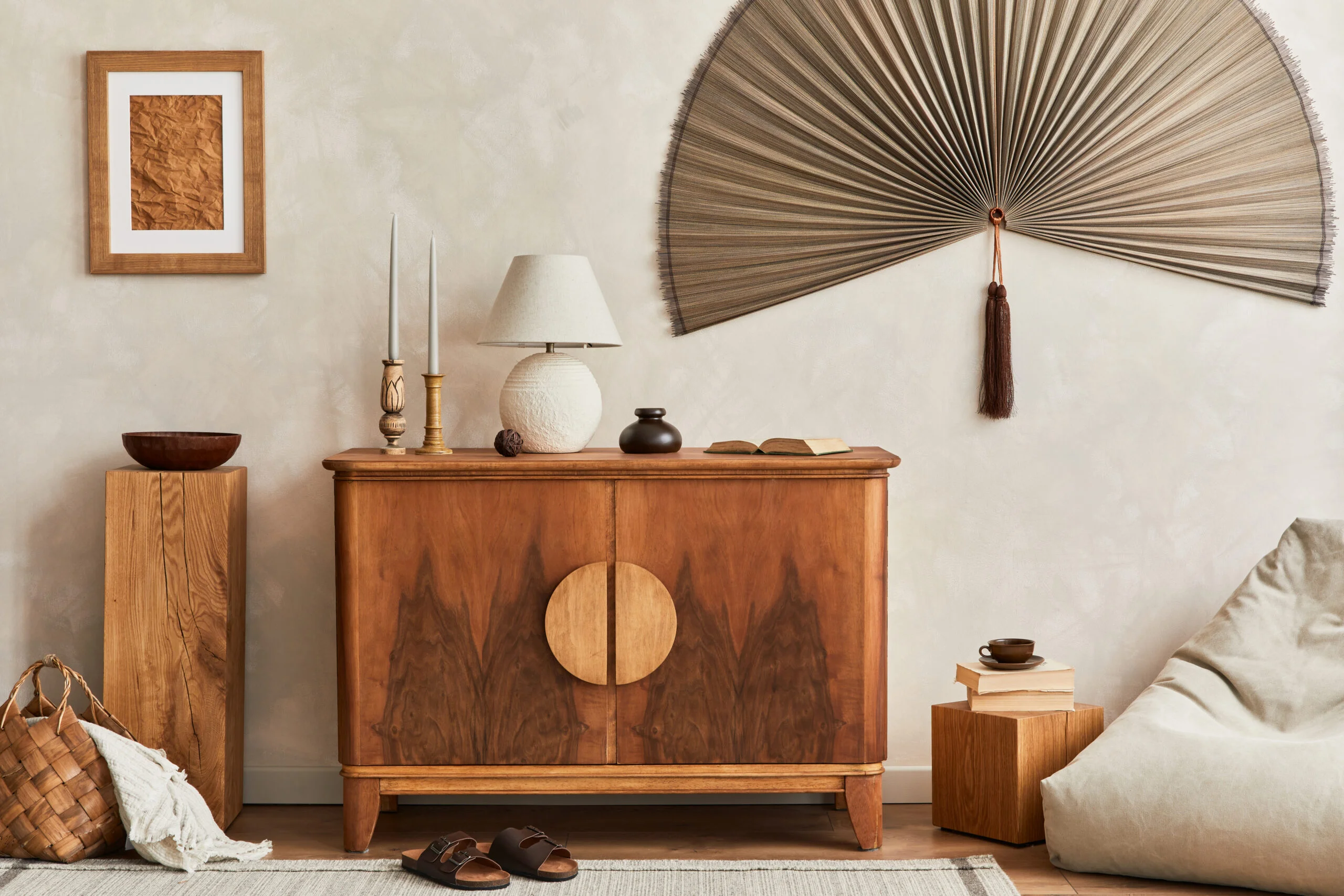 Interior design of neutral living room with stylish retro commode, mock up poster frame, cube, table lamp, decoration and elegant personal accessories in home decor. Template. Japandi concept.